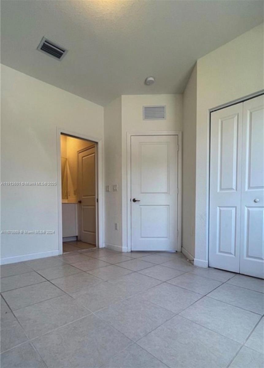 561 Northeast 208th Terrace, Unit 561 Miami, FL 33179 - Photo 30 of 31 an empty room with closet area