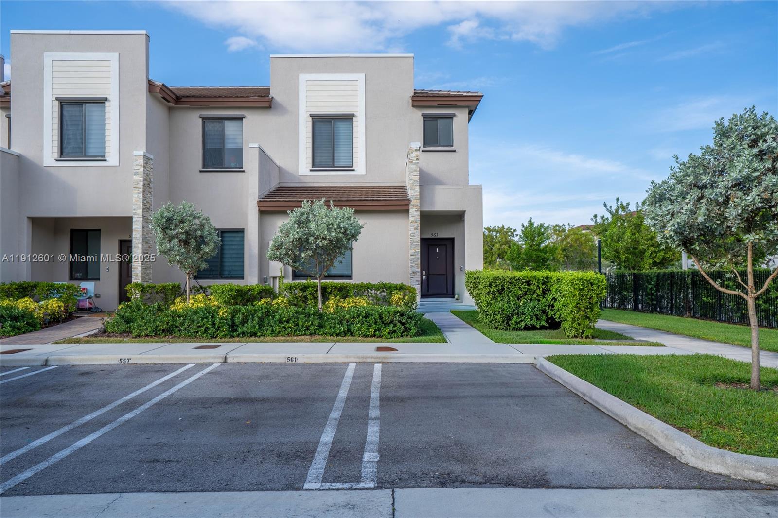 561 Northeast 208th Terrace, Unit 561 Miami, FL 33179 - Photo 5 of 31 a front view of a house with a yard
