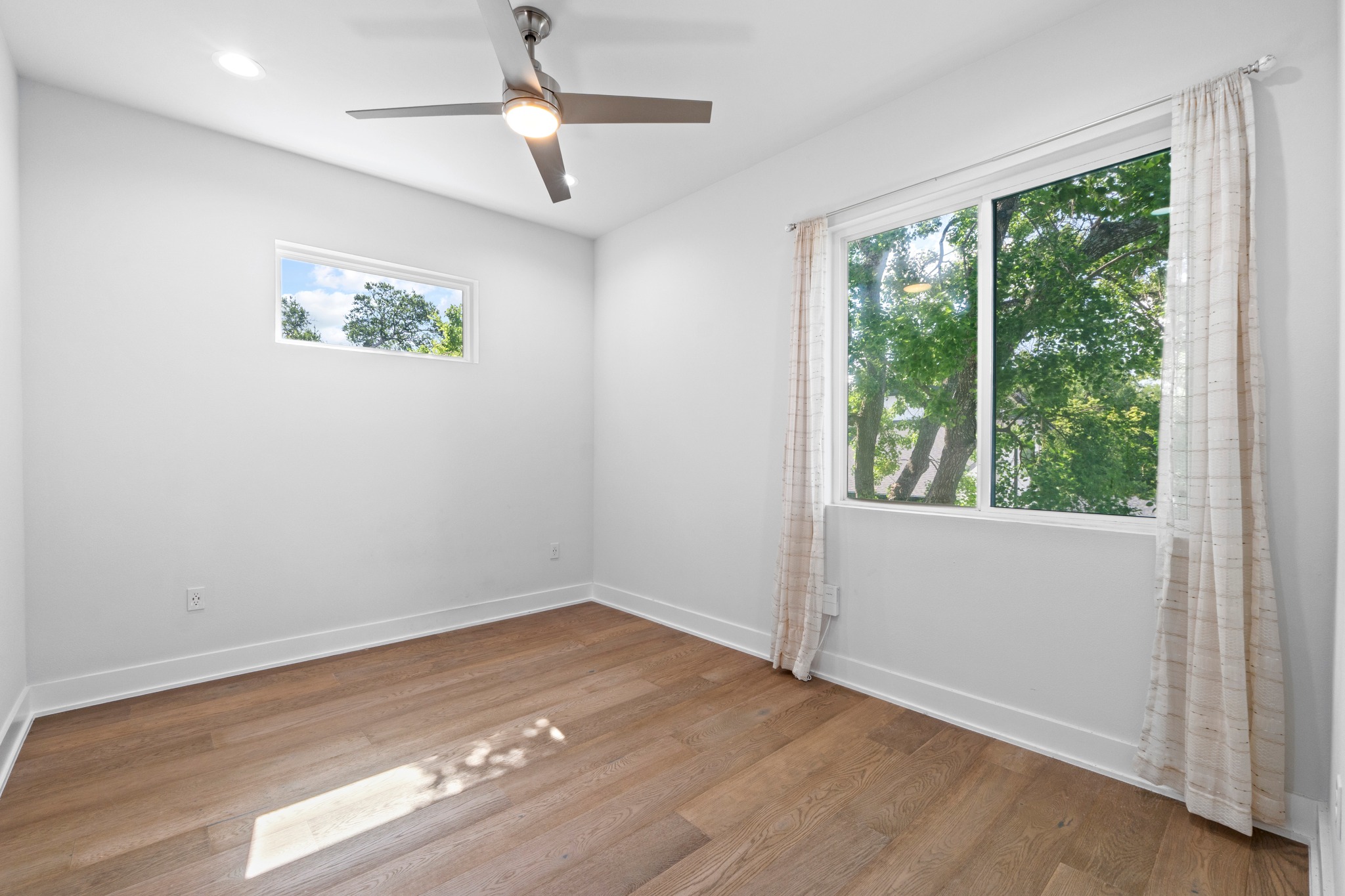 2007 Chestnut Avenue, Unit 1 Austin, TX 78722 - Photo 27 of 32 Hardwood floors and generous natural illumination define this comfortable, airy bedroom.