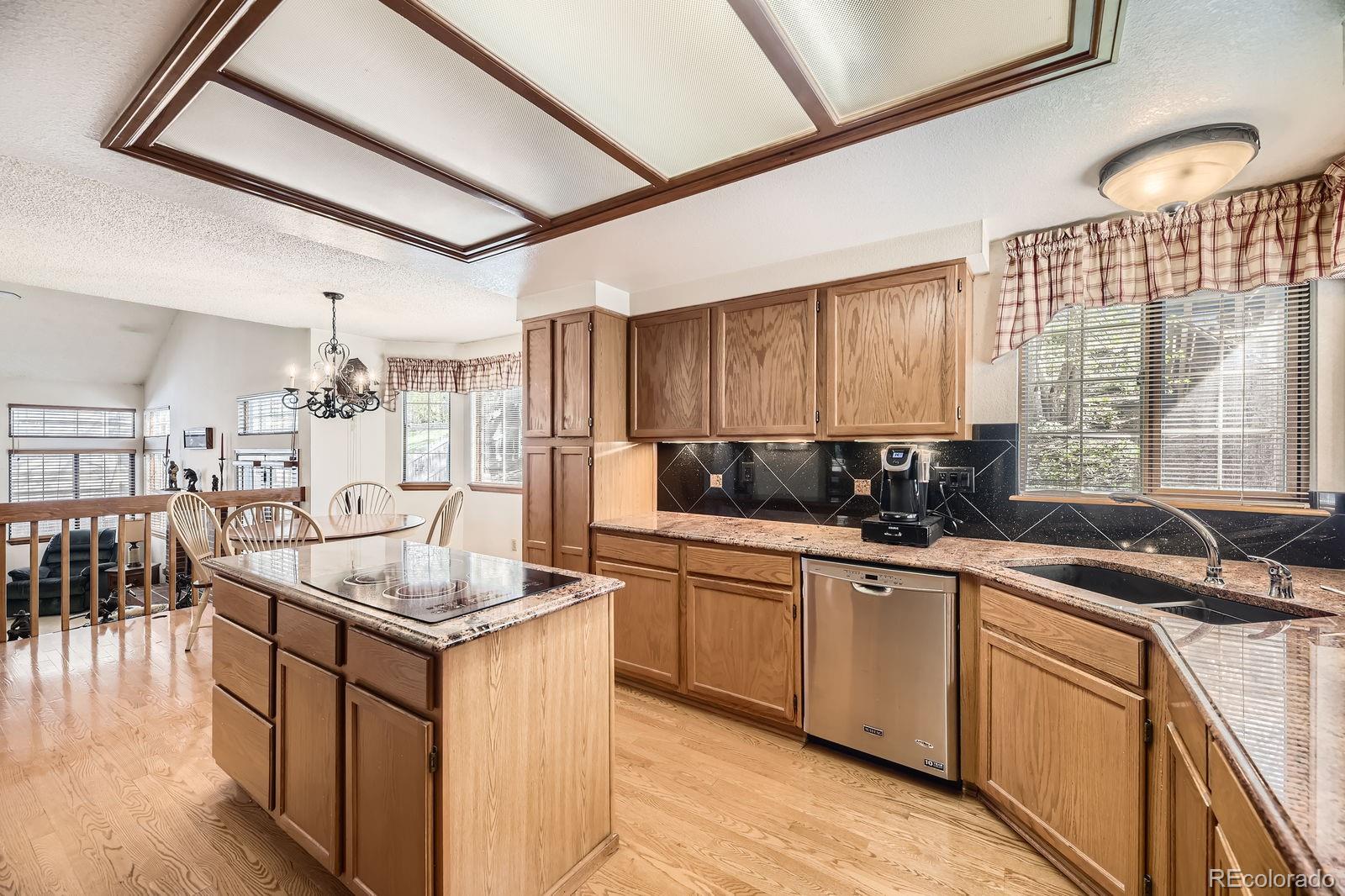 6726 Taft Circle Arvada, CO 80004 - Photo 1 of 41 a kitchen with a sink stove and cabinets