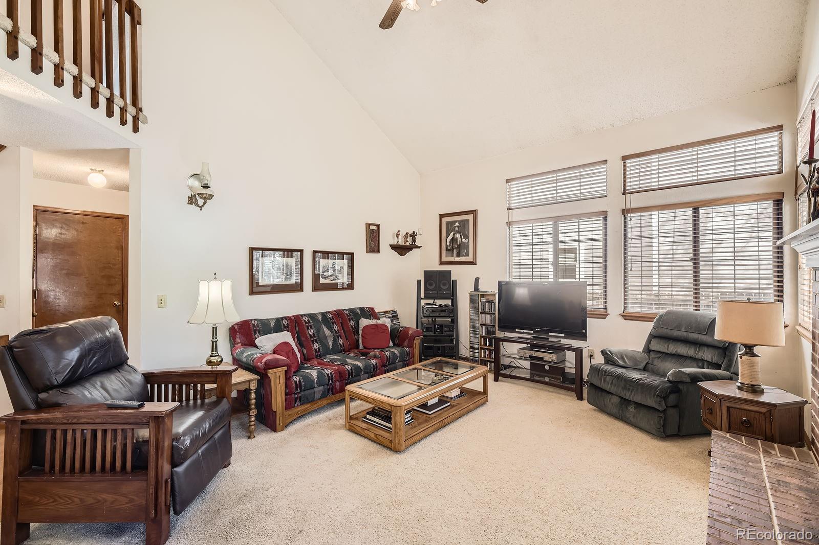6726 Taft Circle Arvada, CO 80004 - Photo 11 of 41 a living room with furniture and a flat screen tv