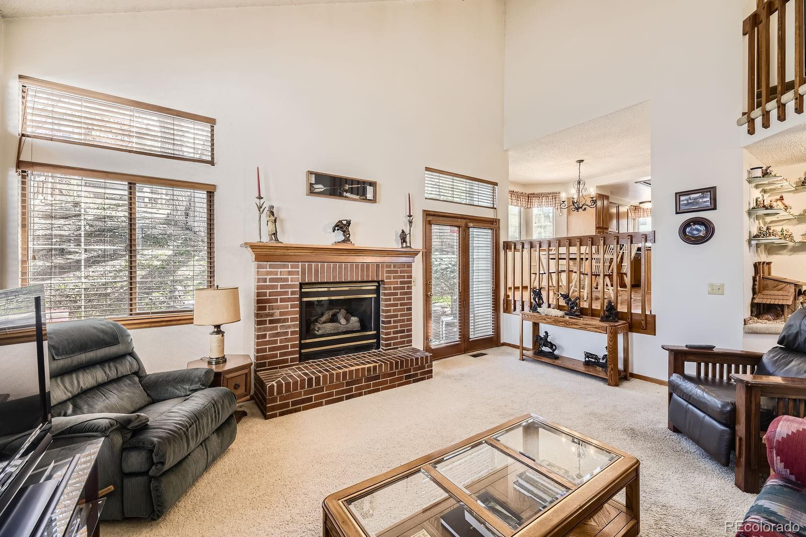 6726 Taft Circle Arvada, CO 80004 - Photo 12 of 41 a living room with furniture and a fireplace