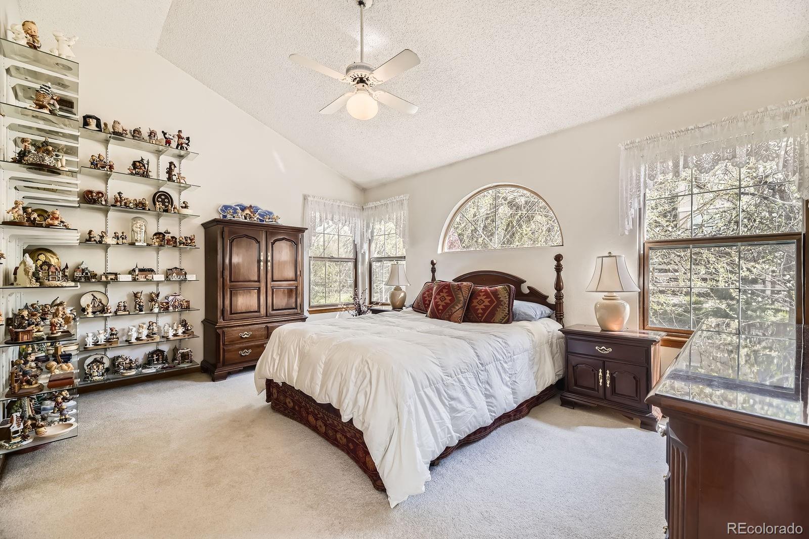 6726 Taft Circle Arvada, CO 80004 - Photo 14 of 41 a bedroom with a bed and a chandelier