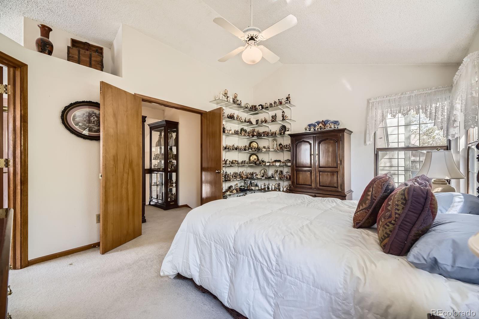6726 Taft Circle Arvada, CO 80004 - Photo 16 of 41 a bedroom with a bed and a chandelier