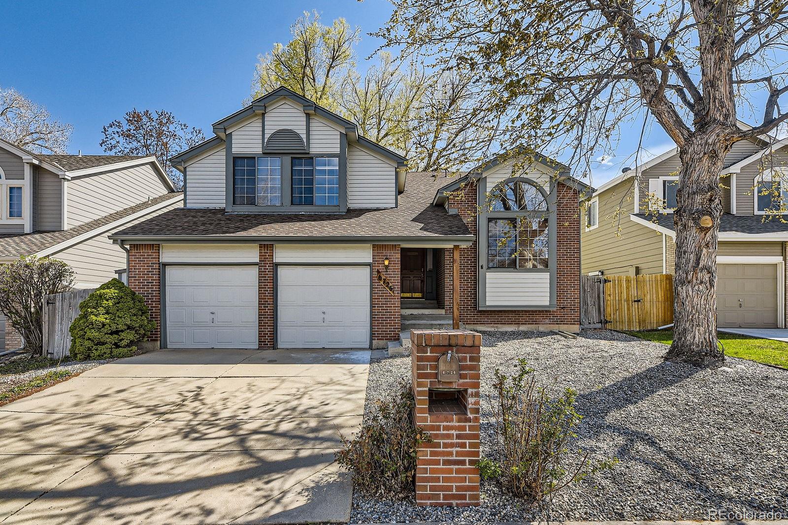 6726 Taft Circle Arvada, CO 80004 - Photo 2 of 41 a front view of a house with a yard