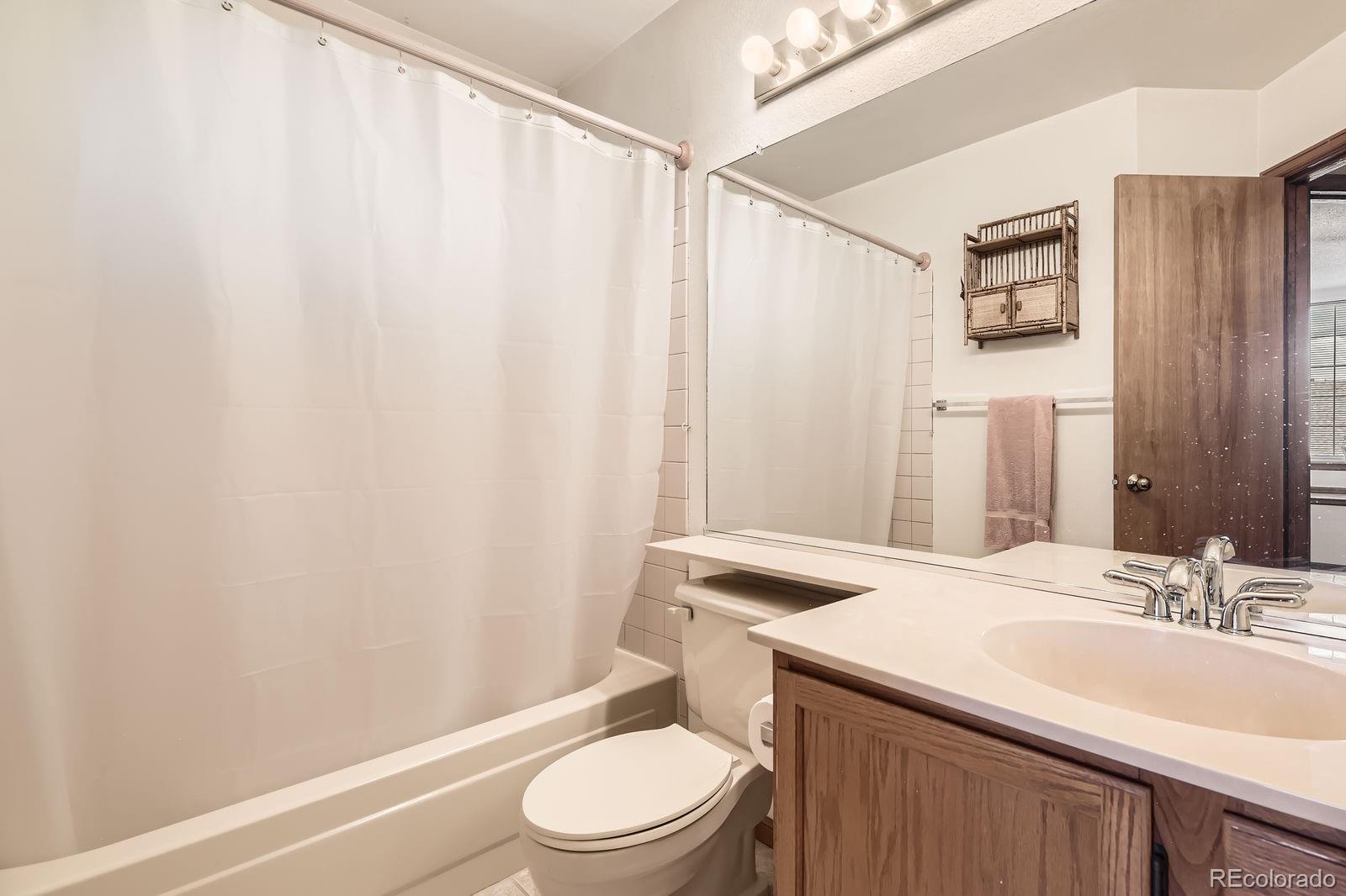6726 Taft Circle Arvada, CO 80004 - Photo 21 of 41 a bathroom with a sink a toilet and shower