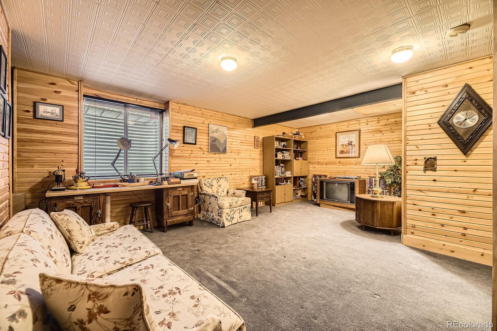 6726 Taft Circle Arvada, CO 80004 - Photo 22 of 41 a bedroom with furniture and a flat screen tv