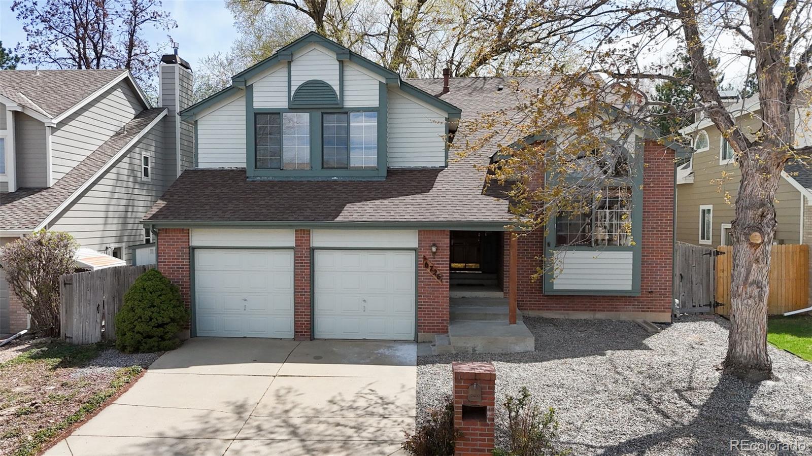 6726 Taft Circle Arvada, CO 80004 - Photo 28 of 41 a front view of a house with a yard