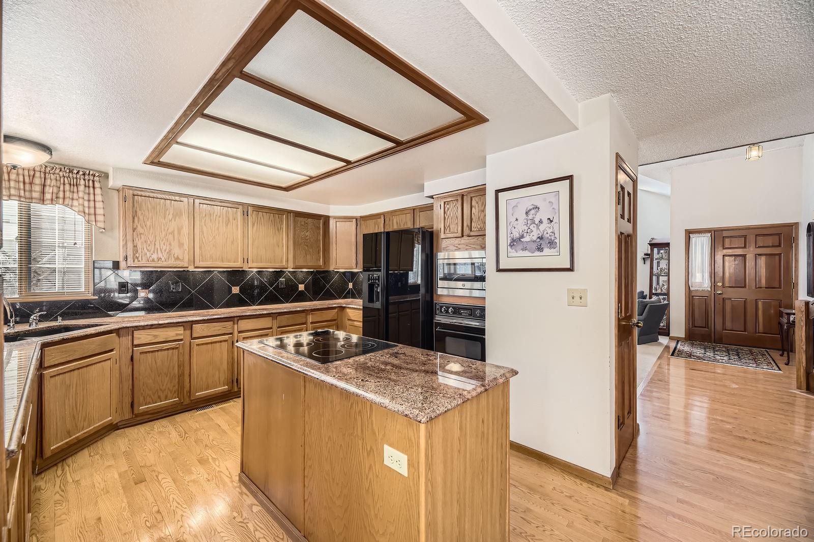 6726 Taft Circle Arvada, CO 80004 - Photo 8 of 41 a kitchen with stainless steel appliances granite countertop a stove and a refrigerator