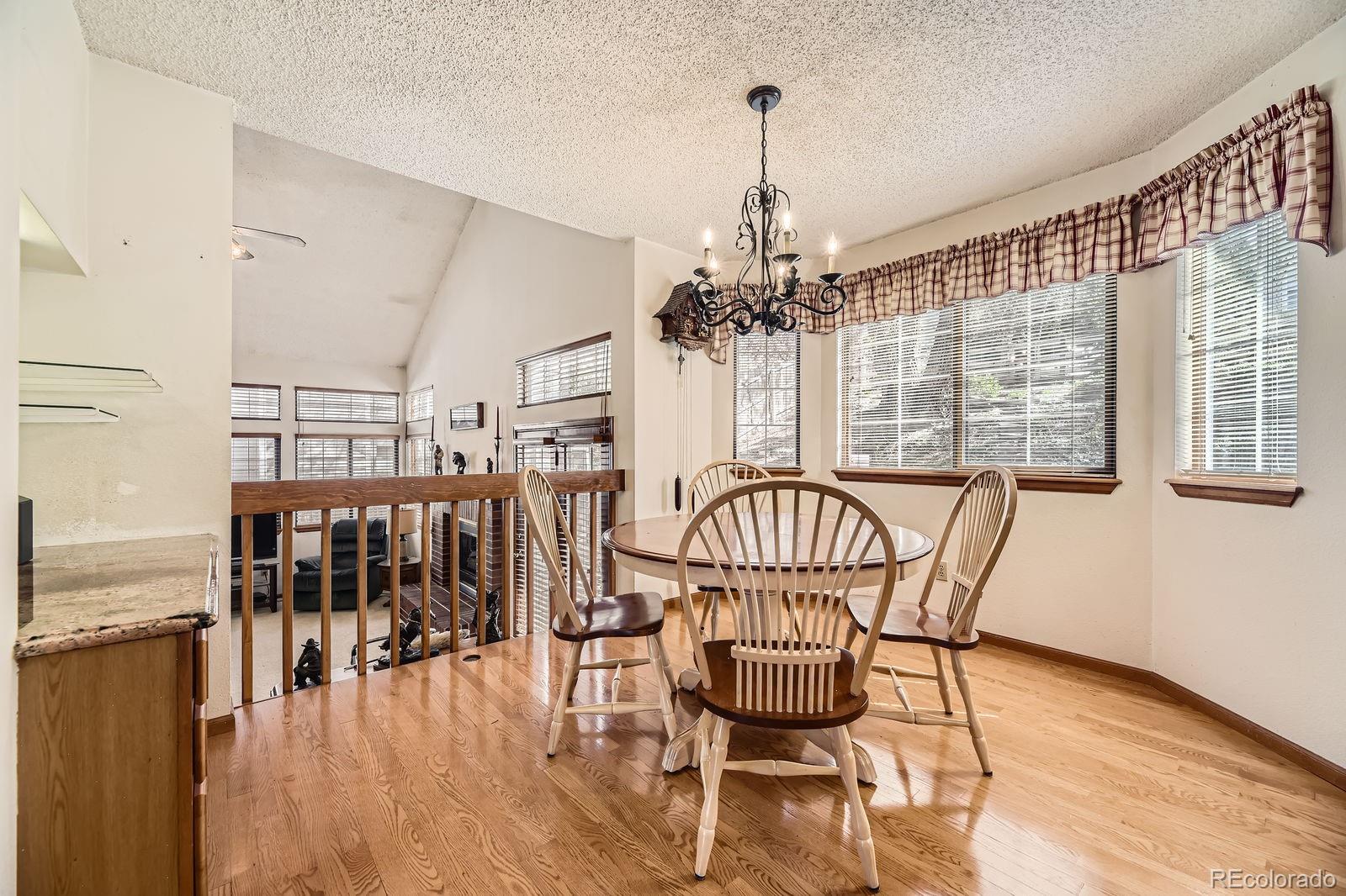 6726 Taft Circle Arvada, CO 80004 - Photo 9 of 41 a view of a dining room with furniture window and wooden floor