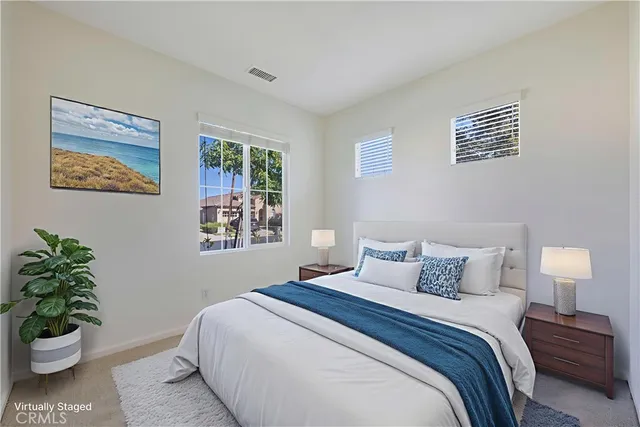 a dining room with furniture a flat screen tv and a large window