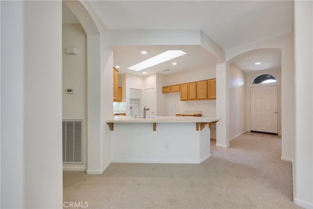 a living room with furniture a chandelier and a flat screen tv