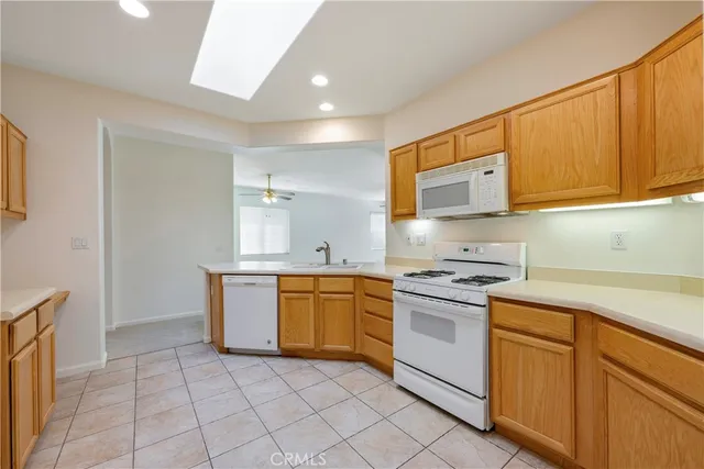 a view of an empty room with a chandelier fan