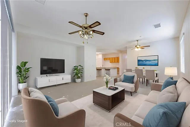 a living room with lots of furniture and a large window