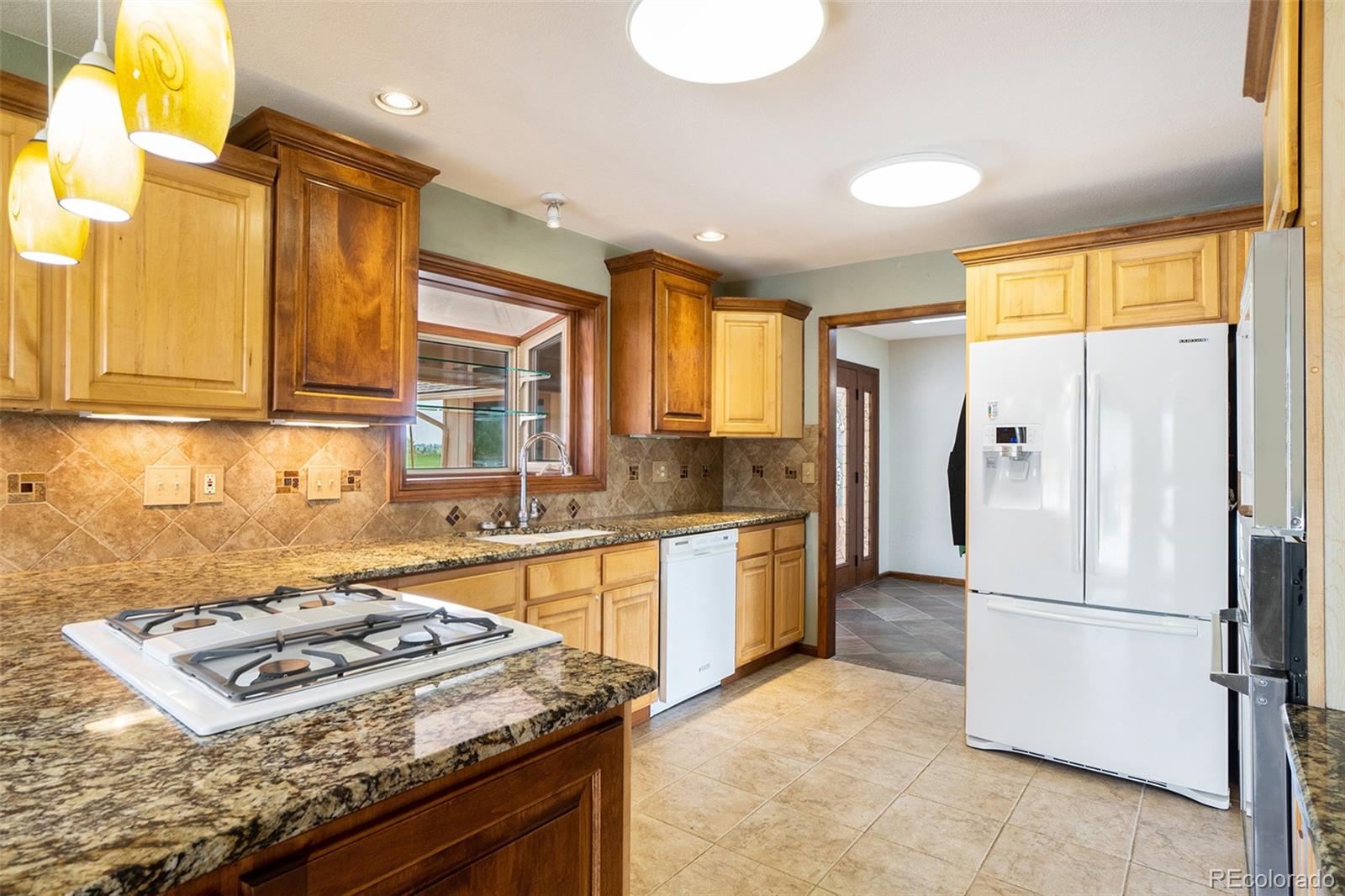 2701 Pheasant Run Berthoud, CO 80513 - Photo 14 of 40 a kitchen with stainless steel appliances granite countertop a refrigerator a stove and a sink