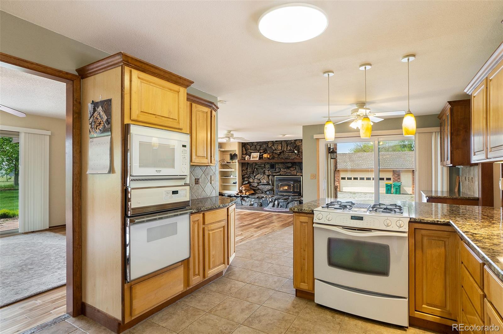 2701 Pheasant Run Berthoud, CO 80513 - Photo 16 of 40 a kitchen with stainless steel appliances a stove a sink and a refrigerator