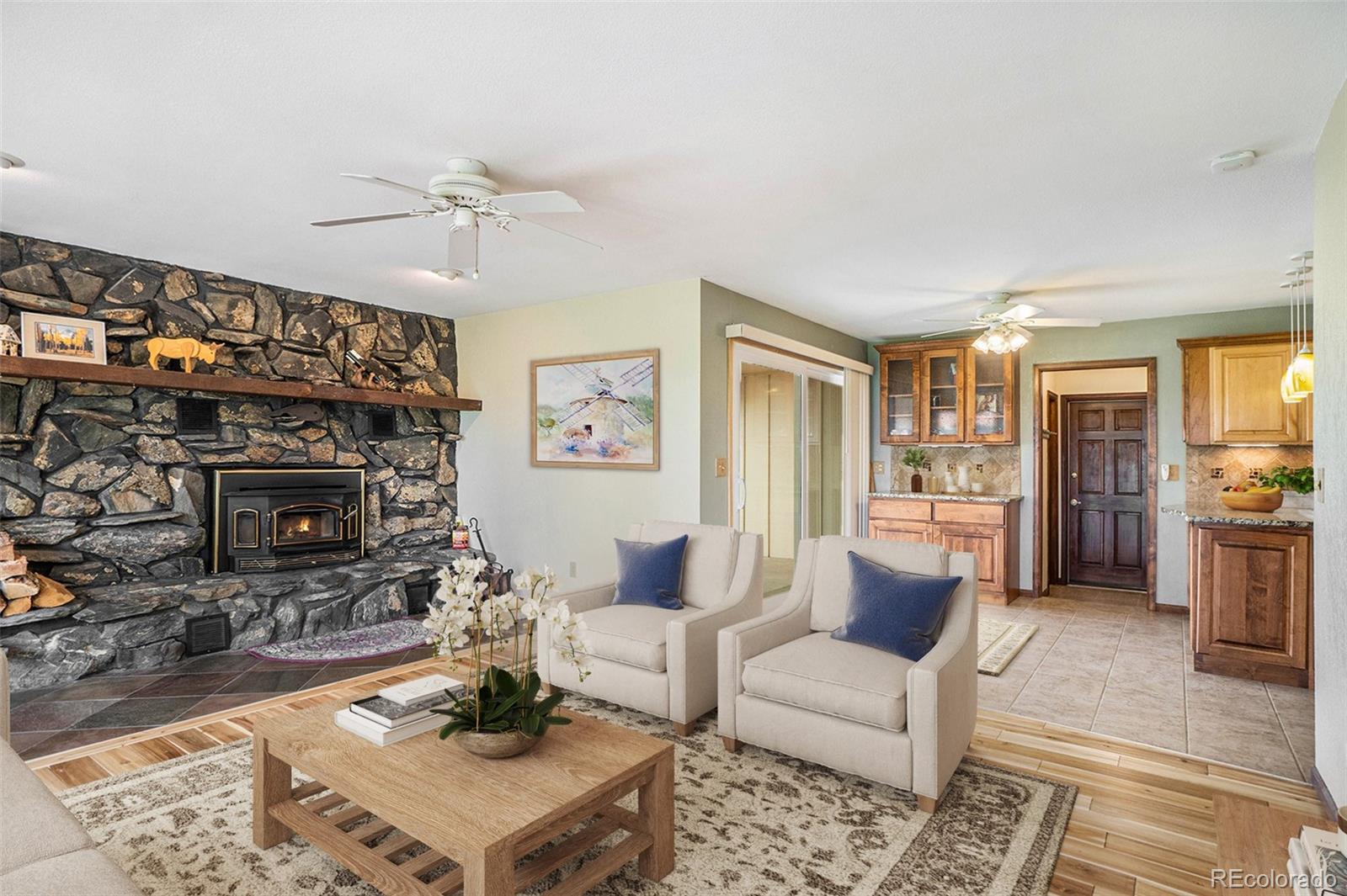 2701 Pheasant Run Berthoud, CO 80513 - Photo 19 of 40 a living room with furniture a fireplace and a flat screen tv