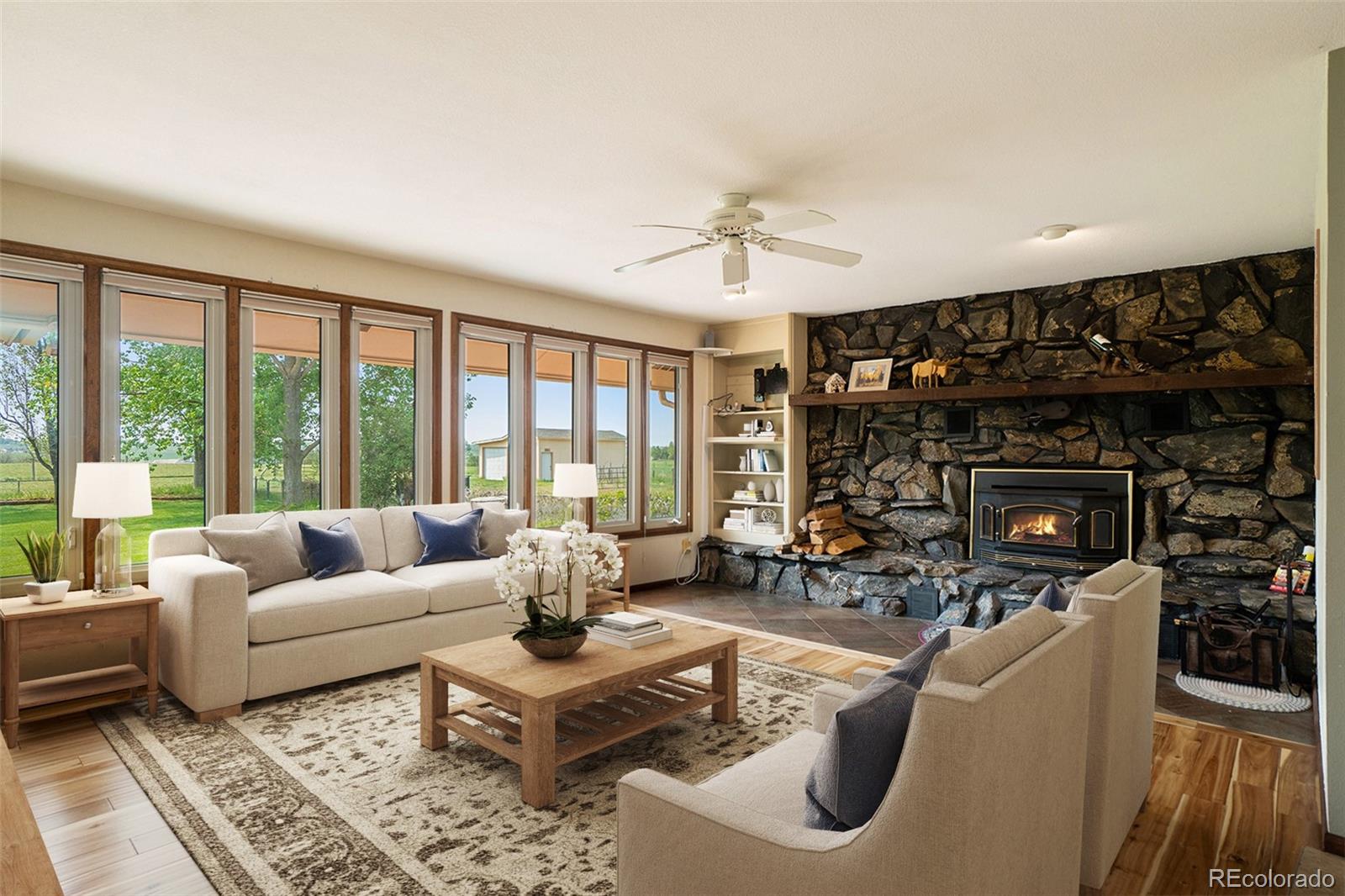2701 Pheasant Run Berthoud, CO 80513 - Photo 20 of 40 a living room with furniture large window and a fireplace