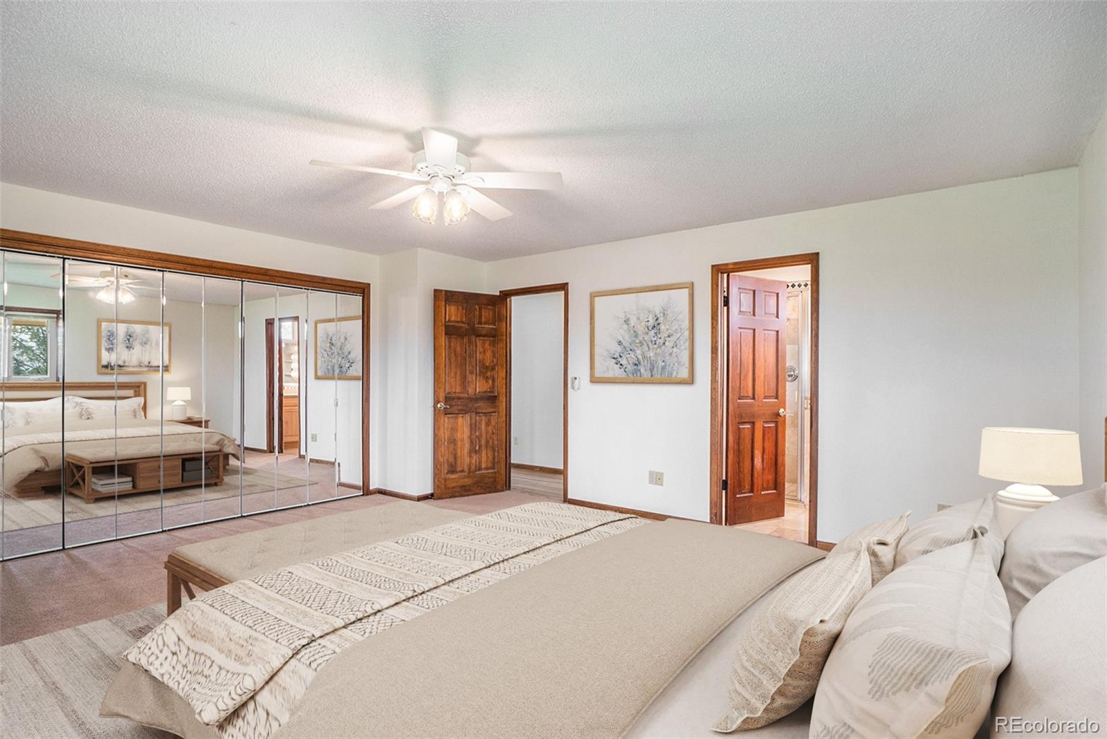 2701 Pheasant Run Berthoud, CO 80513 - Photo 22 of 40 a bedroom with a large bed and a chandelier