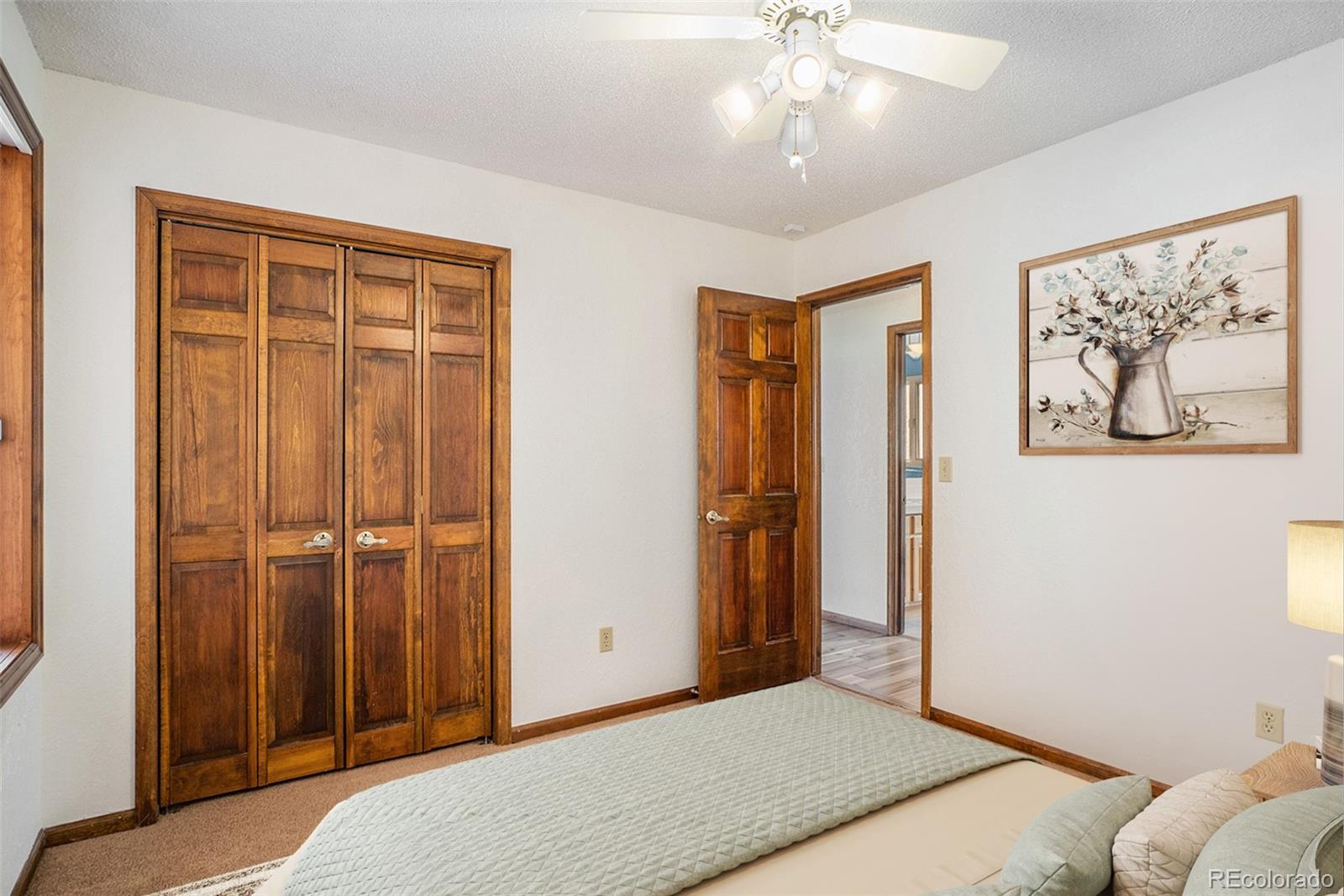 2701 Pheasant Run Berthoud, CO 80513 - Photo 24 of 40 a bedroom with a bed and a chandelier