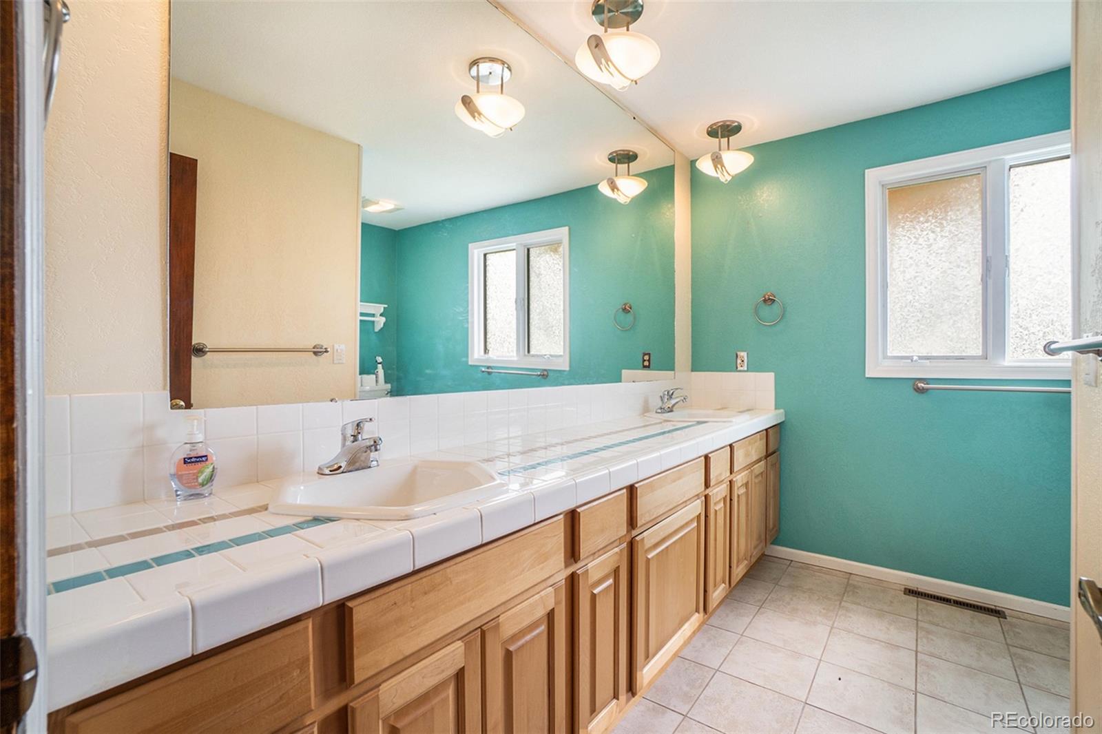 2701 Pheasant Run Berthoud, CO 80513 - Photo 30 of 40 a bathroom with a double vanity sink and a mirror