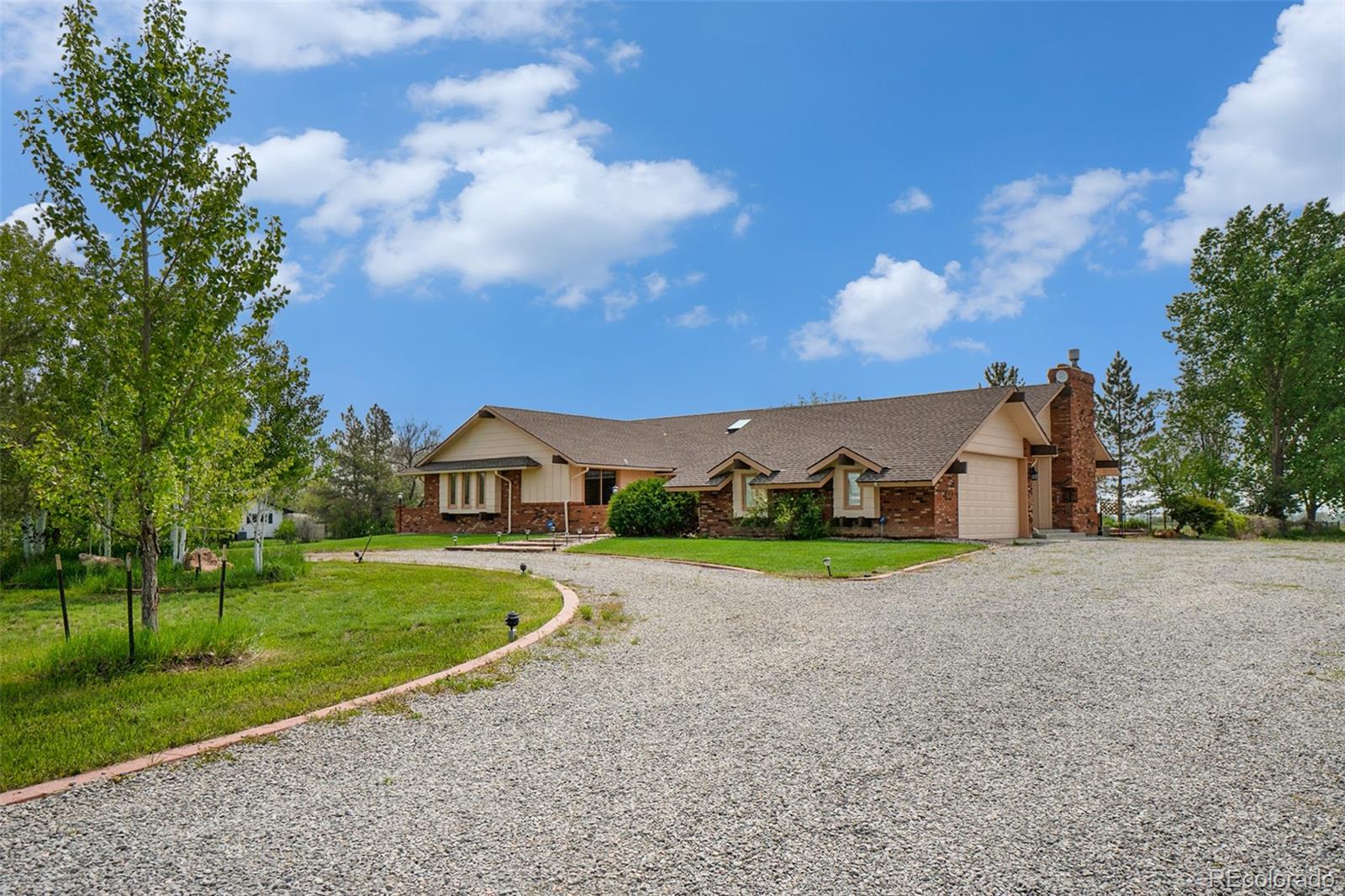 2701 Pheasant Run Berthoud, CO 80513 - Photo 3 of 40 a view of a house with a yard and large trees