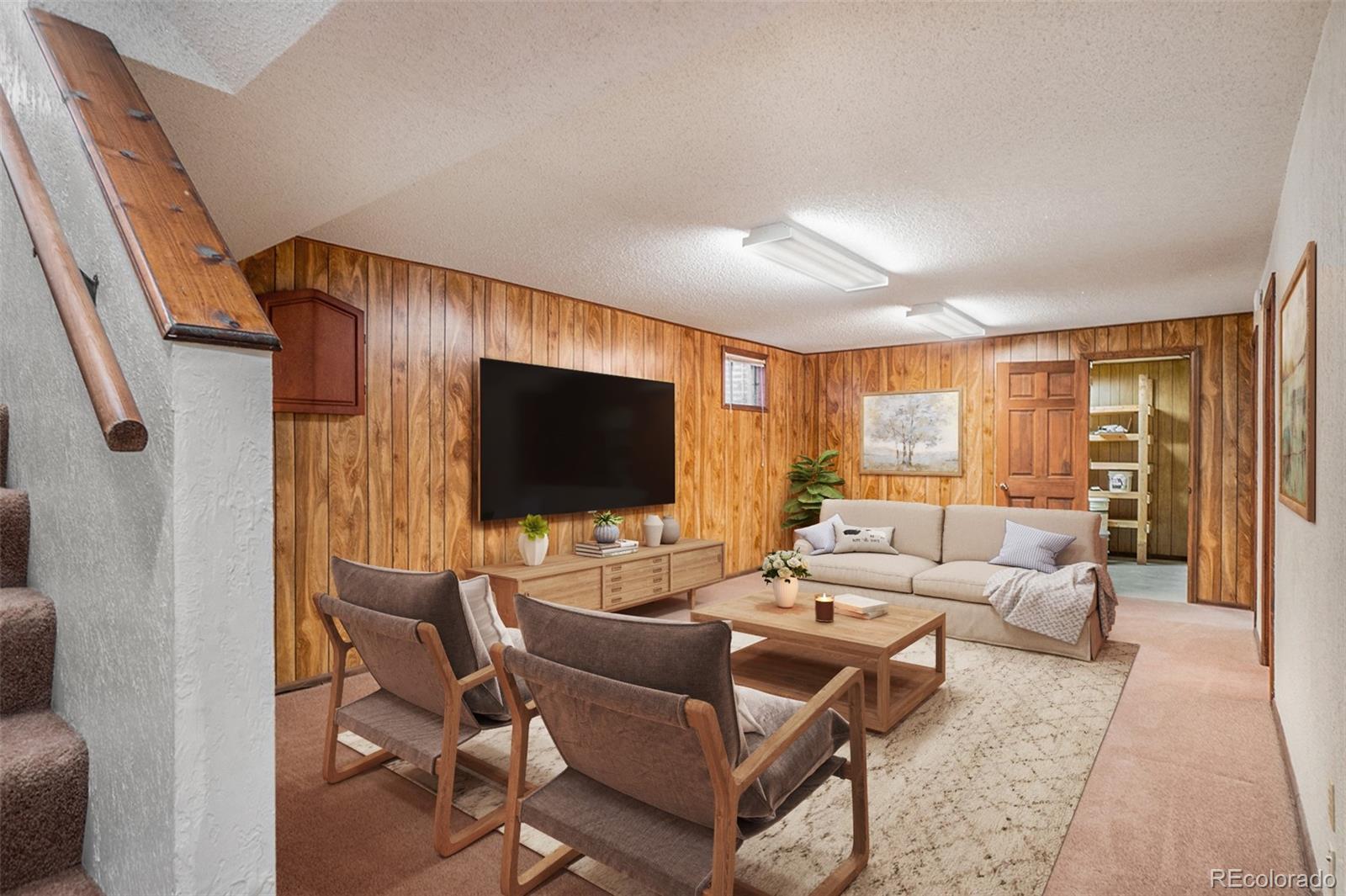 2701 Pheasant Run Berthoud, CO 80513 - Photo 32 of 40 a living room with furniture and a flat screen tv