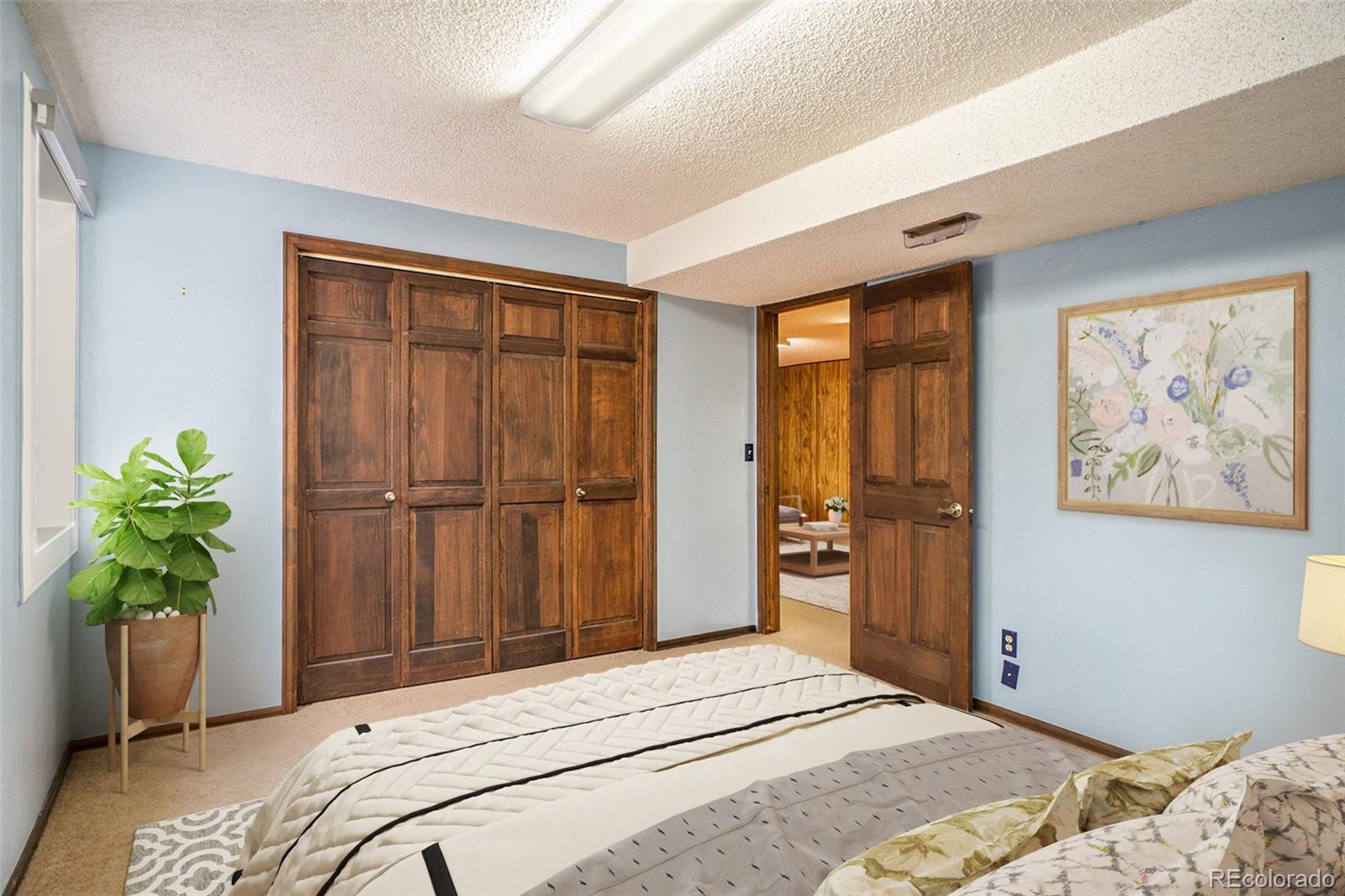 2701 Pheasant Run Berthoud, CO 80513 - Photo 34 of 40 a bedroom with a bed and a potted plant