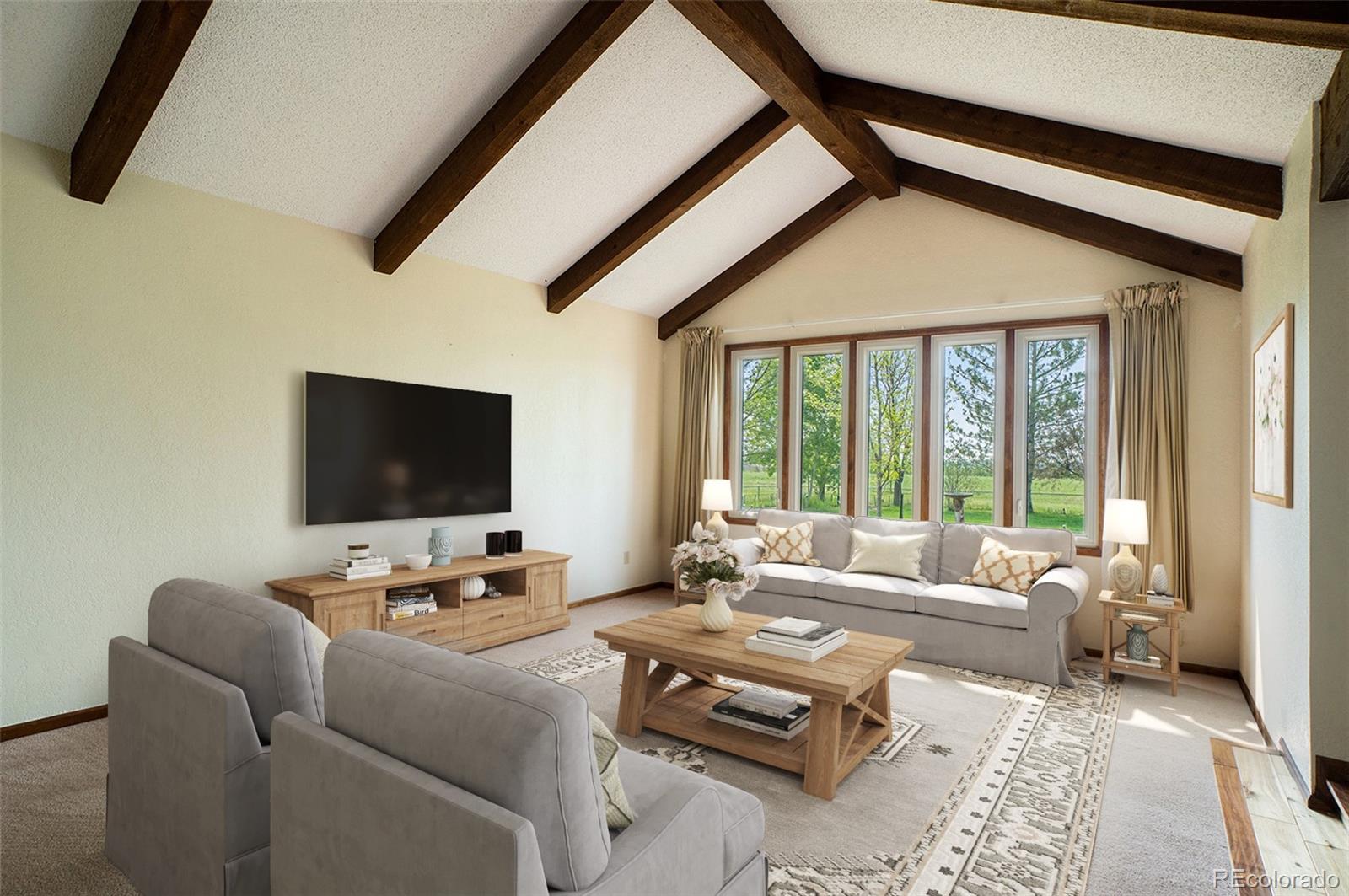 2701 Pheasant Run Berthoud, CO 80513 - Photo 10 of 40 a living room with furniture and a flat screen tv