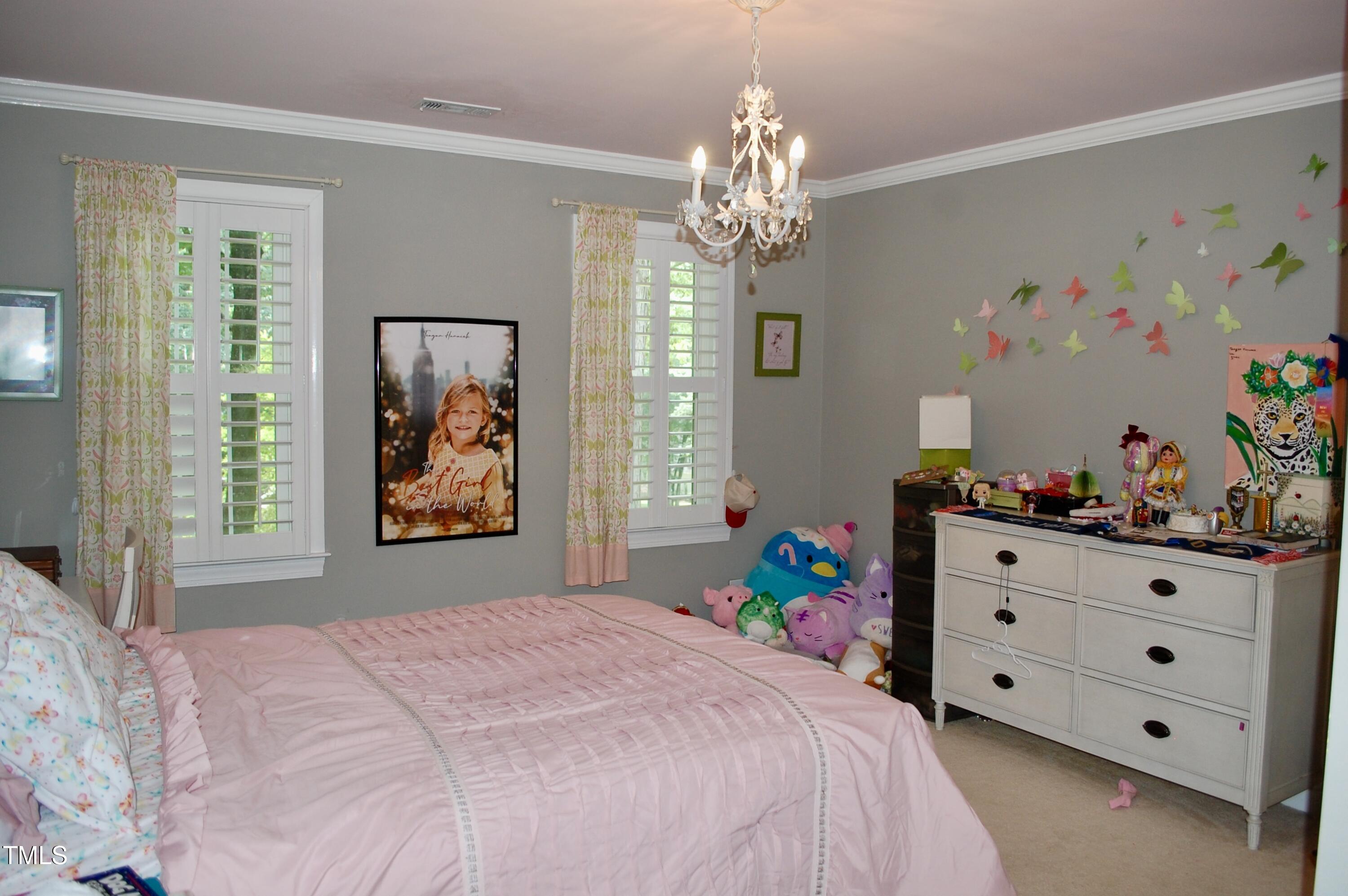 2216 Countrywood Road North Raleigh, NC 27615 - Photo 16 of 22 a bed room with a bed mirror and a window