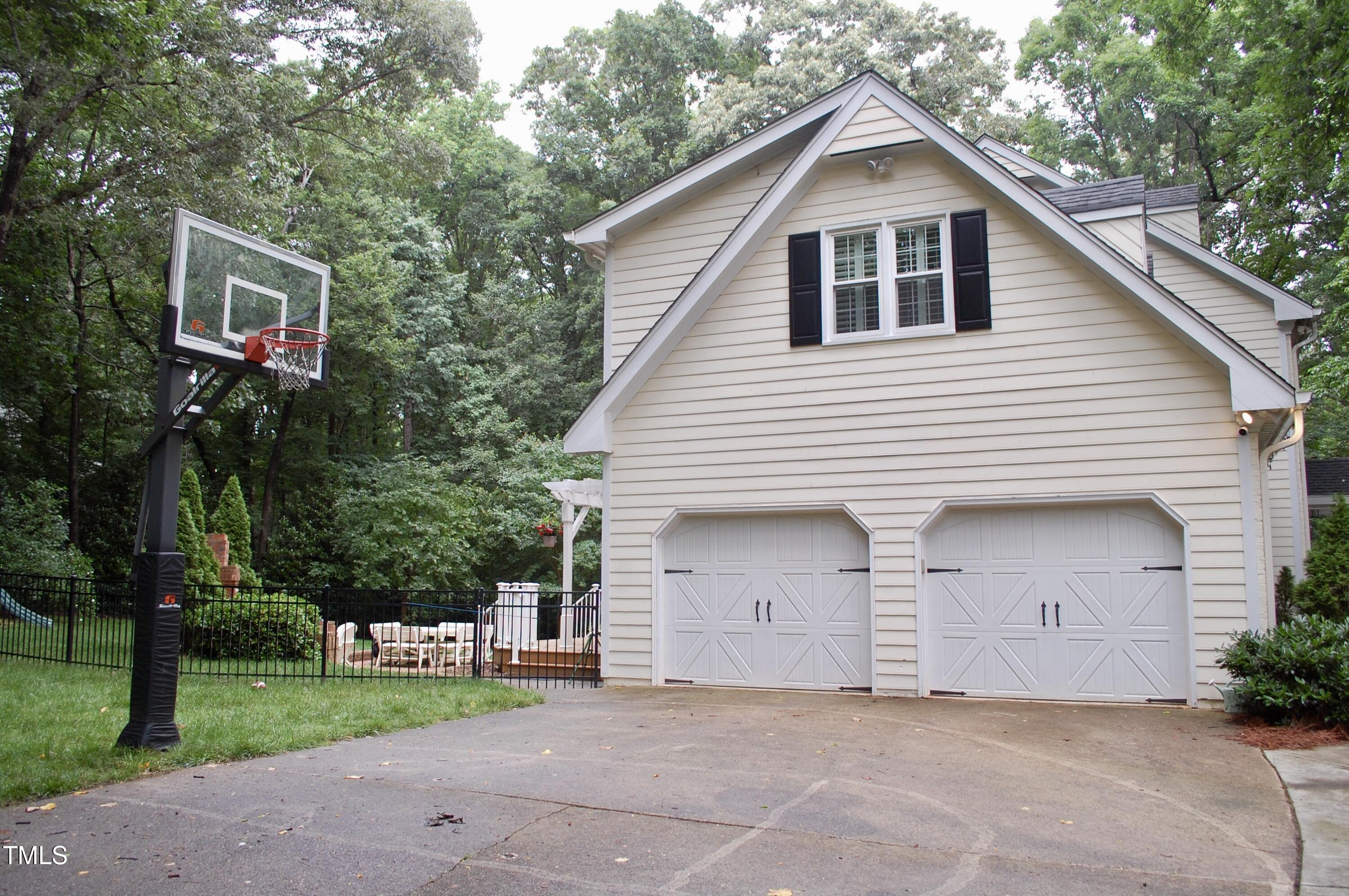 2216 Countrywood Road North Raleigh, NC 27615 - Photo 21 of 22 a front view of a house with a yard and garage