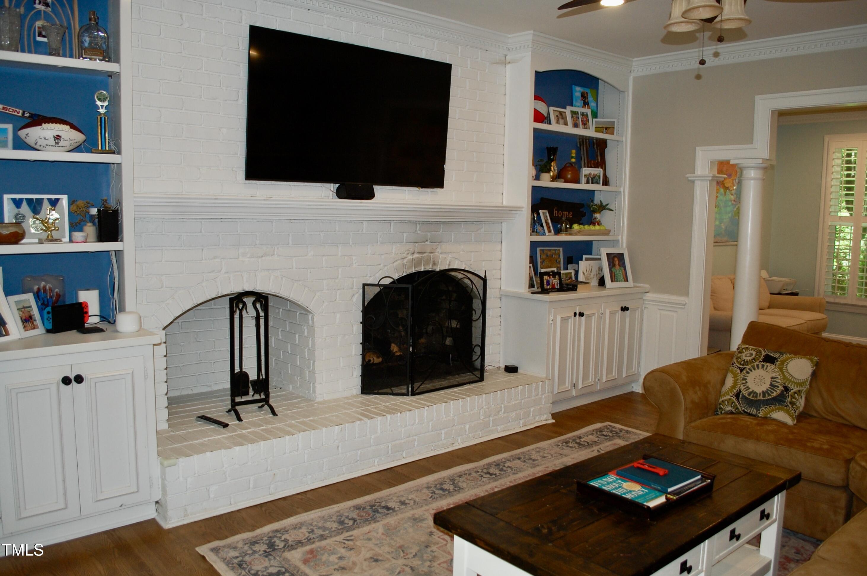 2216 Countrywood Road North Raleigh, NC 27615 - Photo 9 of 22 a living room with fireplace furniture and a flat screen tv
