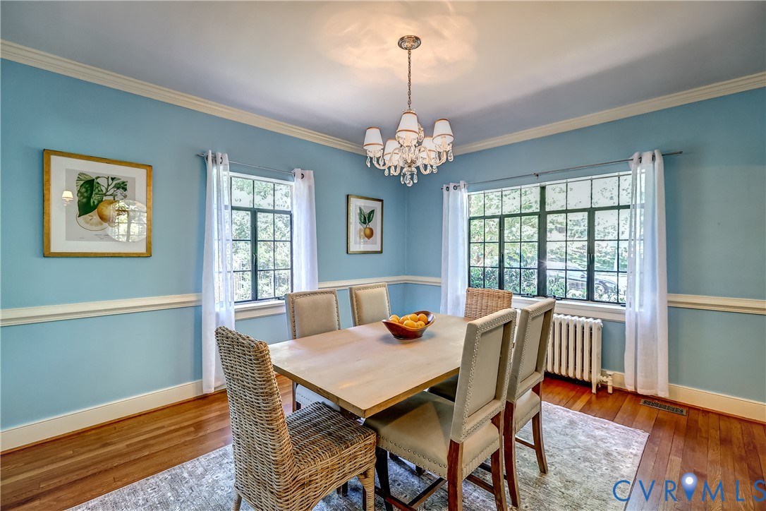 4814 Riverside Drive Richmond, VA 23225 - Photo 15 of 39 a view of a dining room with furniture a chandelier and wooden floor