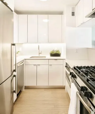 a kitchen with a sink stove and refrigerator