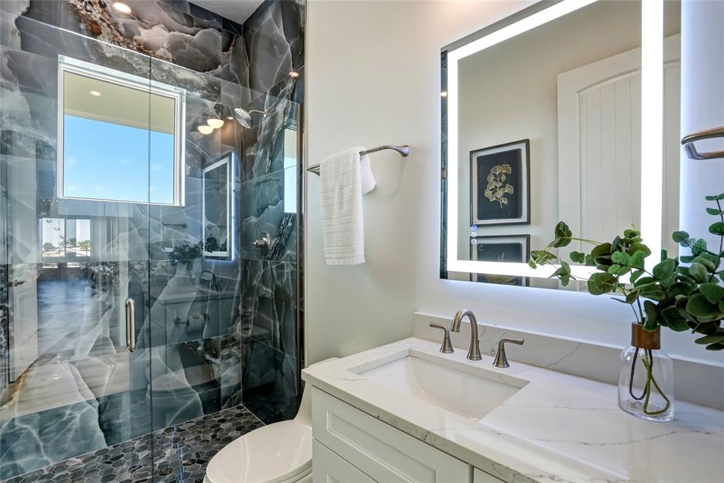 534 Crystal Drive Madeira Beach, FL 33708 - Photo 47 of 68 a bathroom with a sink toilet and shower
