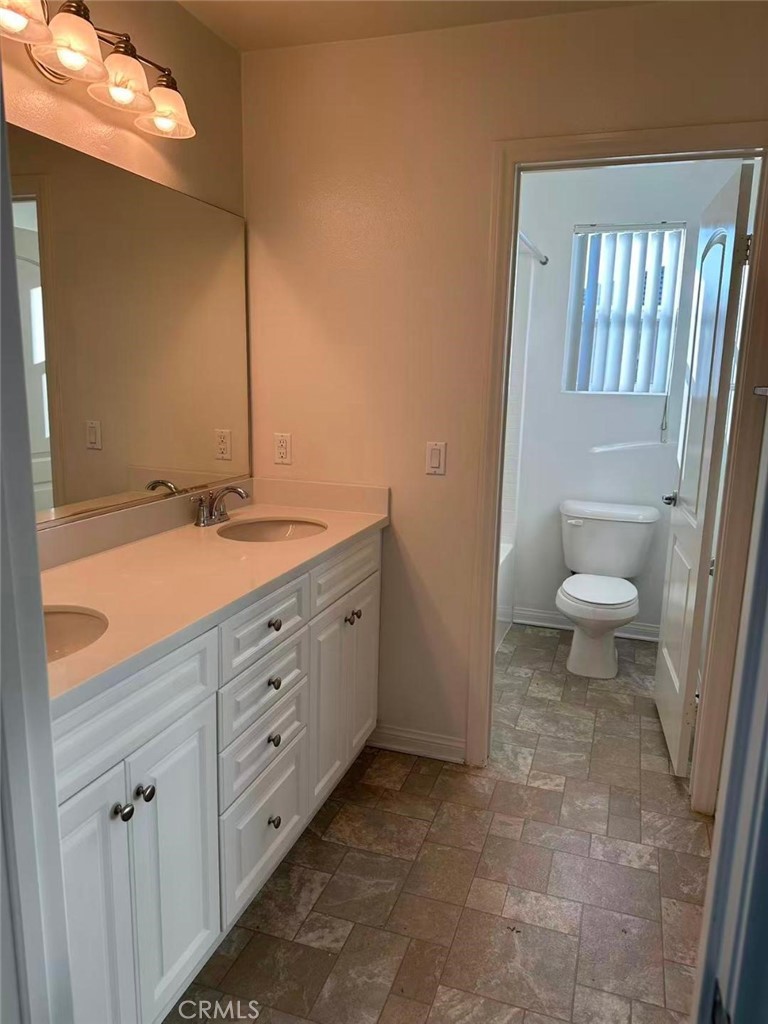 650 Huron Place Claremont, CA 91711 - Photo 18 of 28 a spacious bathroom with a granite countertop sink a toilet and a mirror