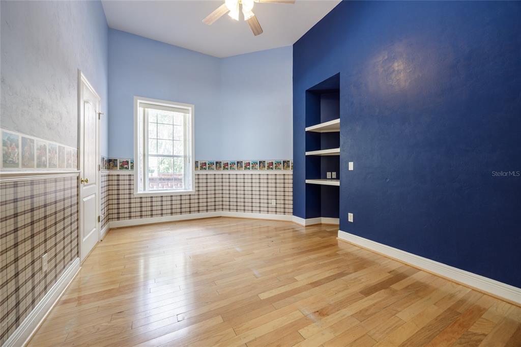 7513 Southwest 35th Way Gainesville, FL 32608 - Photo 18 of 38 a view of an empty room with wooden floor and a window