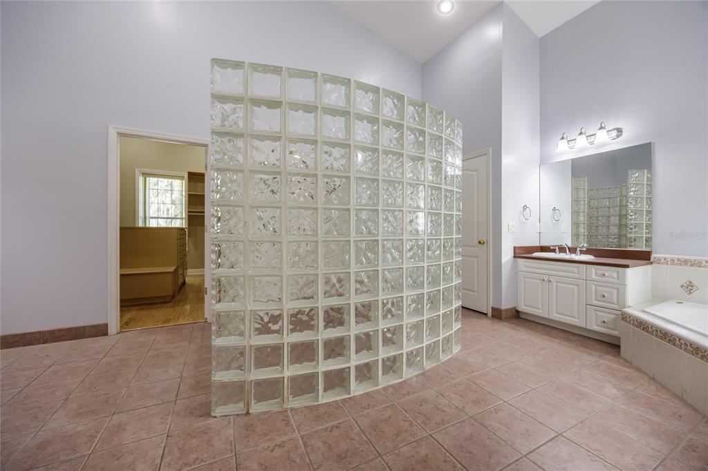 7513 Southwest 35th Way Gainesville, FL 32608 - Photo 19 of 38 a bathroom with a double vanity sink and a mirror