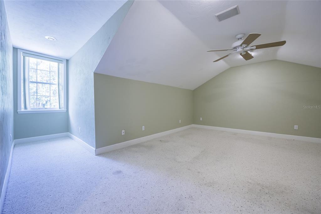 7513 Southwest 35th Way Gainesville, FL 32608 - Photo 29 of 38 an empty room with windows and ceiling fan view