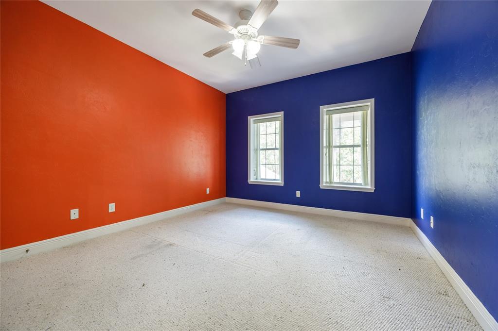 7513 Southwest 35th Way Gainesville, FL 32608 - Photo 30 of 38 an empty room with windows and fan