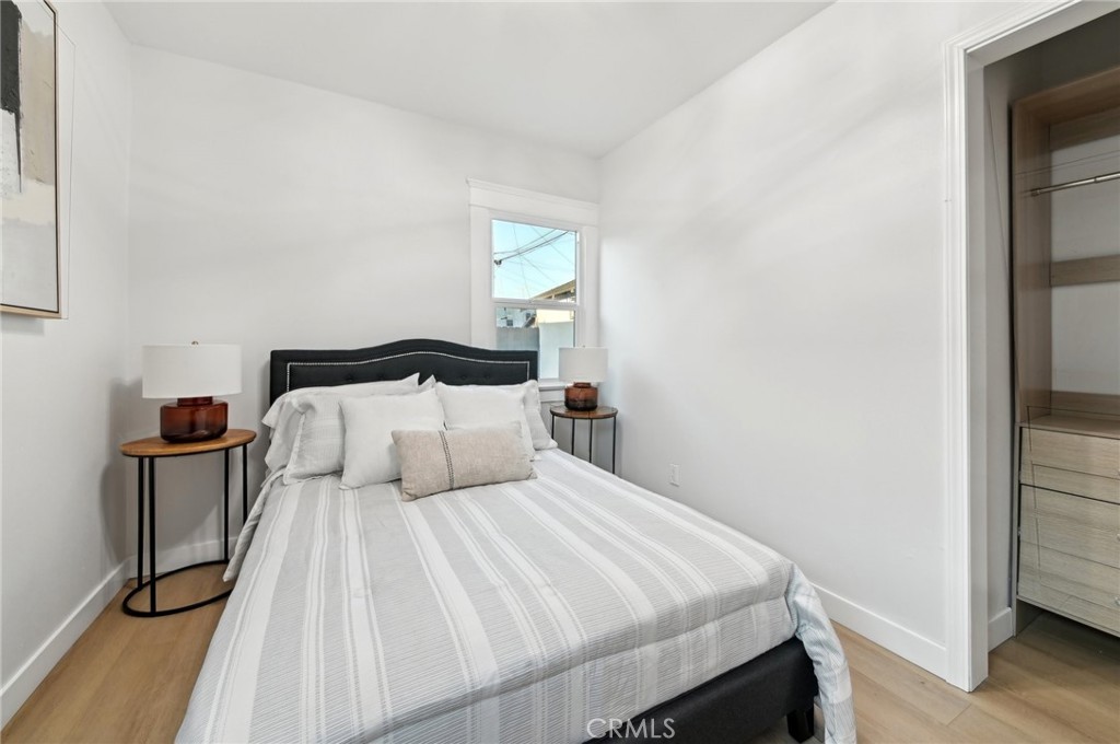 1328 Dawson Avenue Long Beach, CA 90804 - Photo 11 of 22 a bedroom with a bed and wooden floor