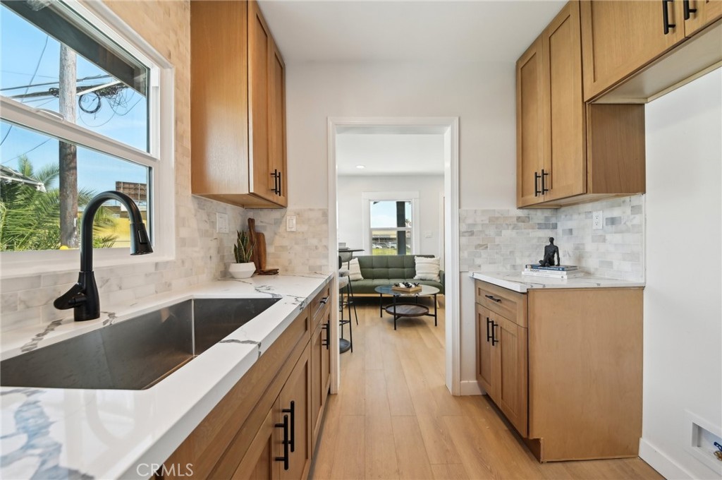1328 Dawson Avenue Long Beach, CA 90804 - Photo 4 of 22 a kitchen with granite countertop a sink a counter top space and cabinets