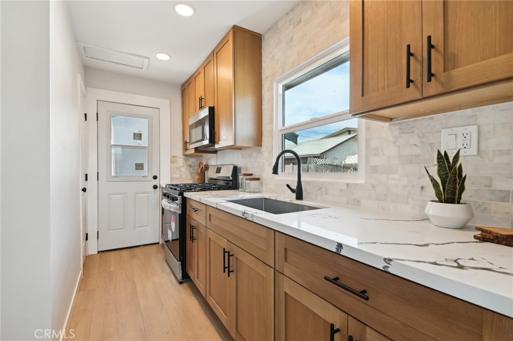 1328 Dawson Avenue Long Beach, CA 90804 - Photo 5 of 22 a kitchen with a sink stove and cabinets