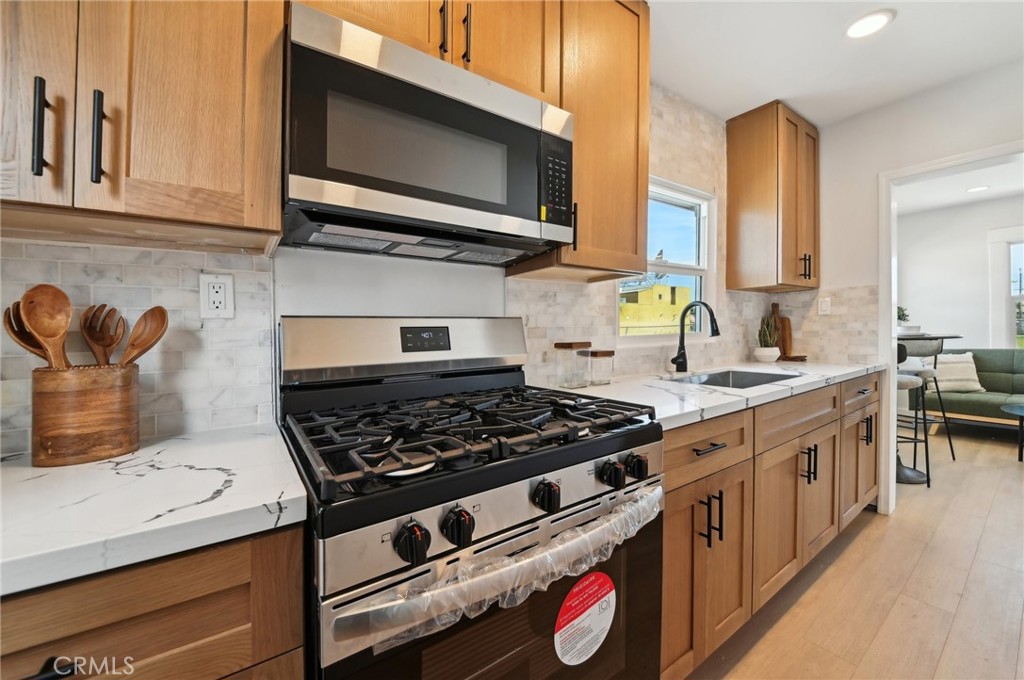1328 Dawson Avenue Long Beach, CA 90804 - Photo 6 of 22 a kitchen with a stove and a microwave