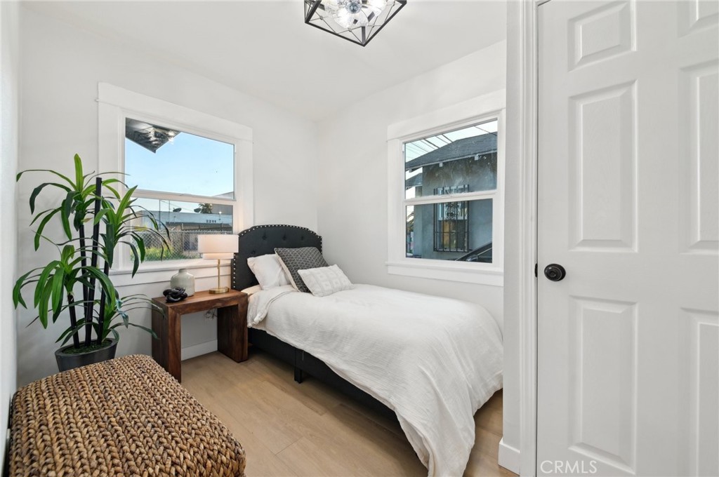 1328 Dawson Avenue Long Beach, CA 90804 - Photo 7 of 22 a bedroom with a bed and a potted plant