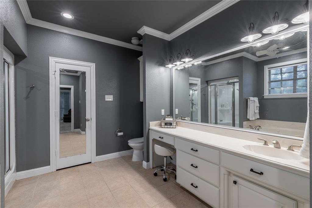 320 Rustic Oaks Road Combine, TX 75159 - Photo 23 of 40 First Primary bathroom with a shower stall, vanity, crown molding, and tile patterned floors
