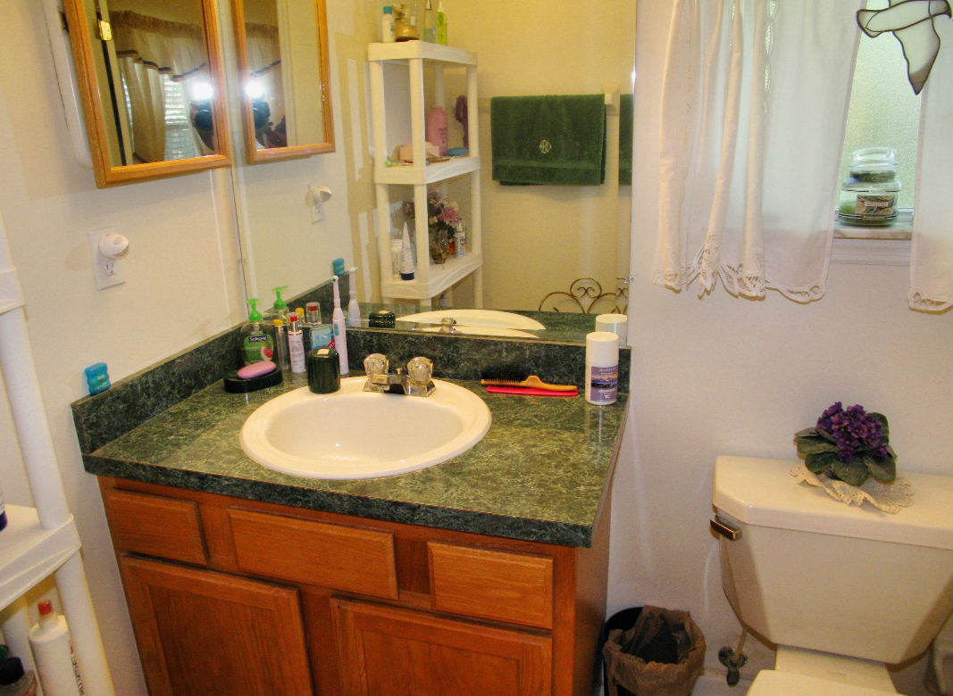 954 Stocks Street Atlantic Beach, FL 32233 - Photo 11 of 21 a bathroom with a granite countertop sink and a mirror