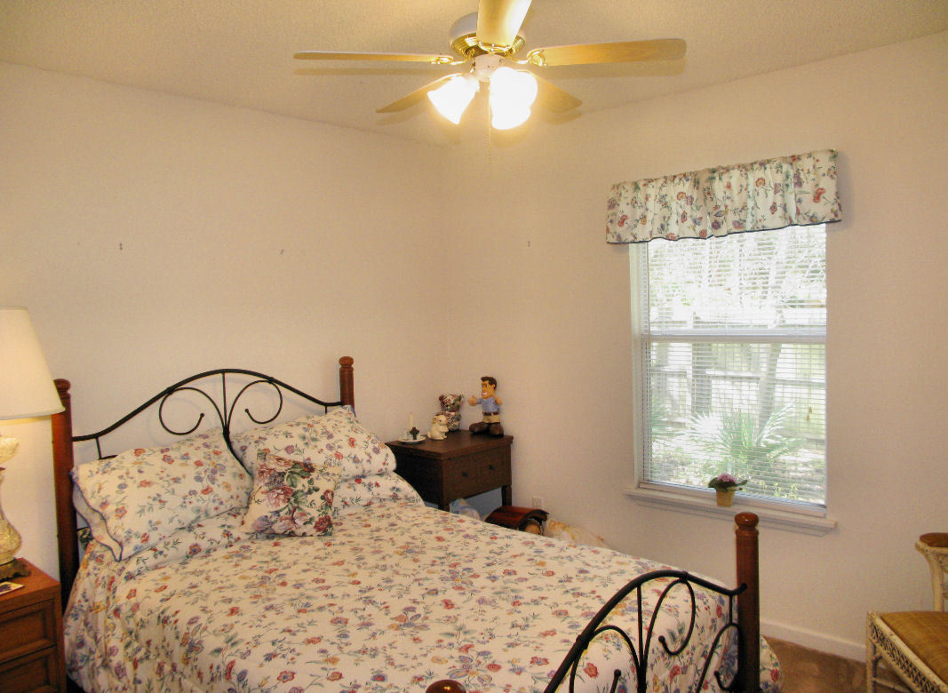 954 Stocks Street Atlantic Beach, FL 32233 - Photo 12 of 21 a bedroom with a bed and a chandelier