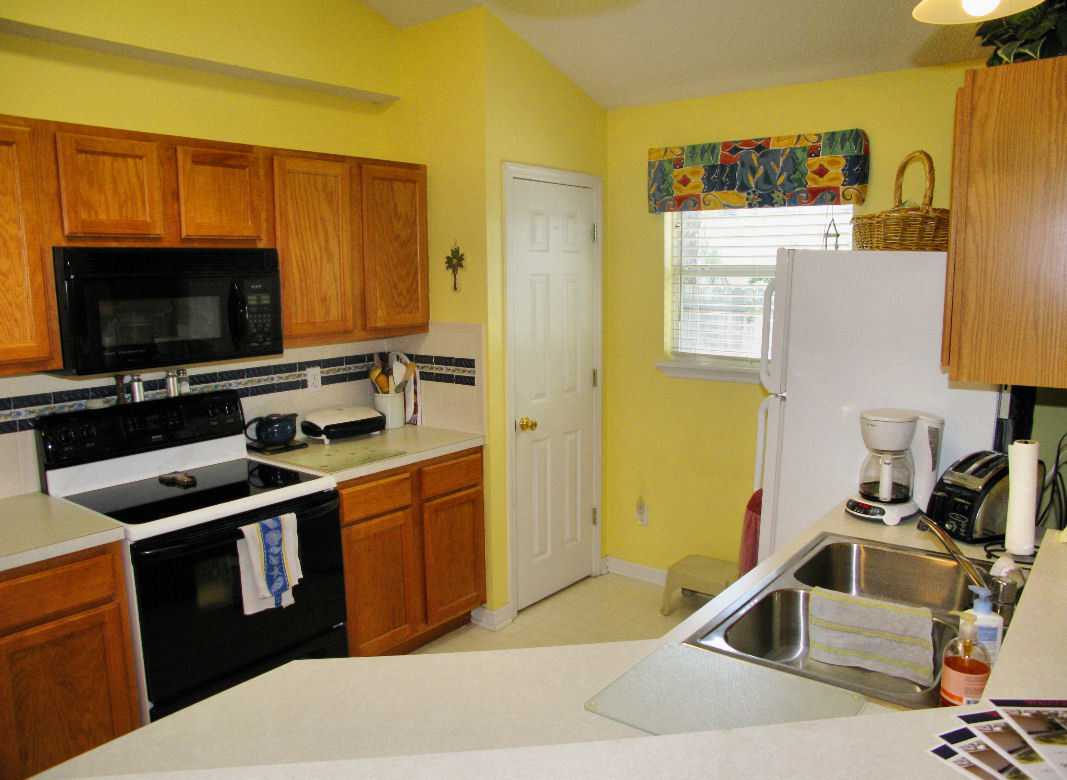 954 Stocks Street Atlantic Beach, FL 32233 - Photo 7 of 21 a kitchen with stainless steel appliances a stove a sink and a microwave