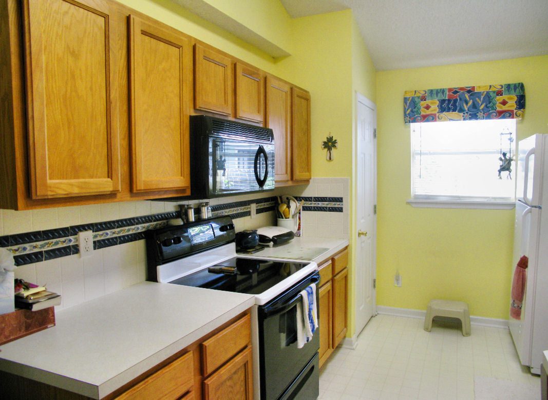 954 Stocks Street Atlantic Beach, FL 32233 - Photo 9 of 21 a kitchen with a sink a stove and a refrigerator